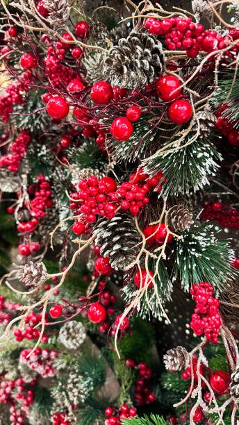 istock holidays traditional decorations concept.Christmas tree branches with red berries, toys and cones. Christmas decorations in the interior. The concept of preparing for the New Year holidays 2185073319