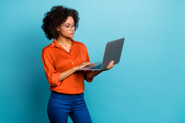 istock Portrait of beautiful trendy wavy-haired girl using laptop copy space study learn isolated on vivid blue color background 2185074446