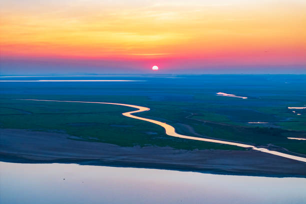 istock Beautiful sunset, grassland and lake 2185075041