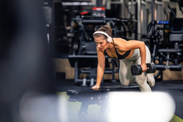 istock Female person using weights in the gym. Strength training. 2185075368