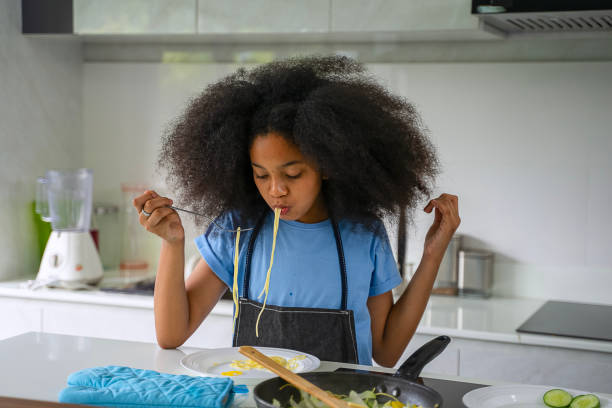 istock Daughter is cooking food in the kitchen. 2185075585