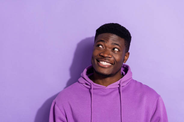 istock Portrait of attractive cheerful guy thinking making decision copy empty space isolated over bright violet lilac color background 2185077326