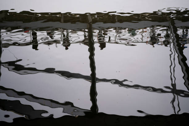 pedestrians and bridge, silhouette in water