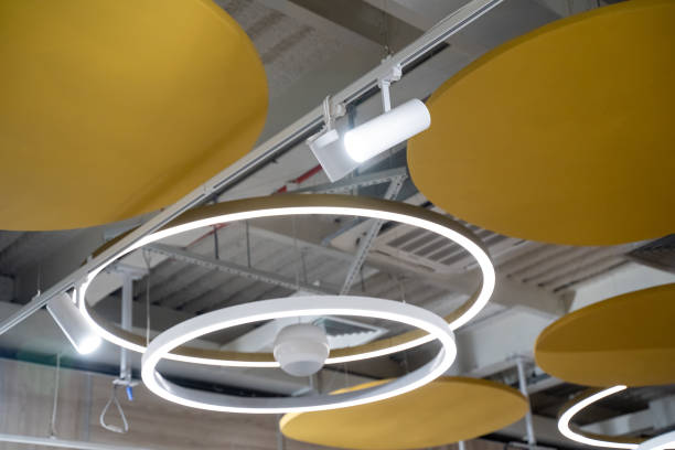 istock Imagine a ceiling adorned with vibrant yellow and pristine white circles, complemented by stylish lights hanging down from it, creating a captivating and cheerful atmosphere 2185080342