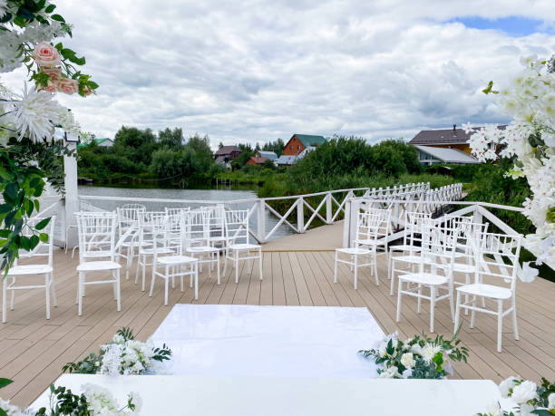 istock The beautiful wooden deck has been meticulously decorated for a charming wedding ceremony, featuring elegant white chairs and an assortment of vibrant flowers adorning the space 2185080503