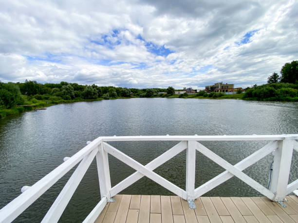 istock A view of a lake from a dock with a white railing 2185080512