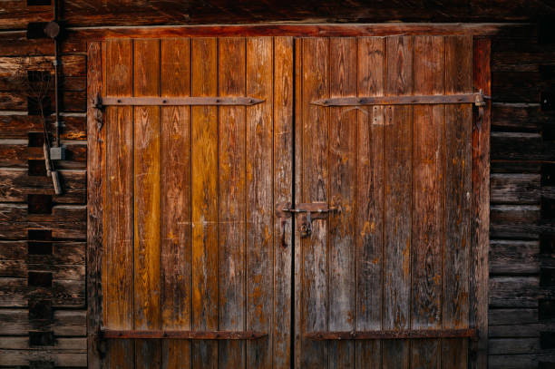 istock Beautiful Rustic Wooden Double Doors Featuring an Intricate Weathered Texture Design 2185080697
