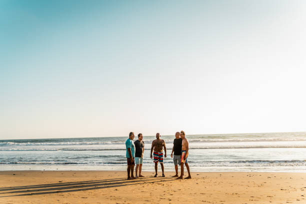 istock Senior friends men talking on the beach 2185081273