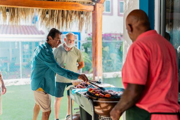 istock Senior friends men talking during barbecue at home 2185083116