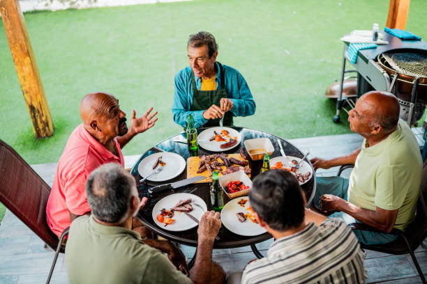 istock Senior friends men talking during barbecue at home 2185083269