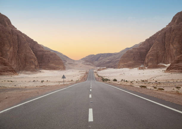 Long asphalt road in the desert.