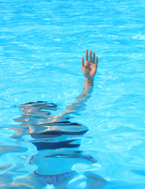 istock hand emerges from the pool while trying to hold her breath underwater 2185087666