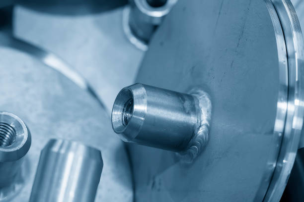 Close up scene the part assembly process by welding process in the light blue scene. The metalworking process by turning machine.