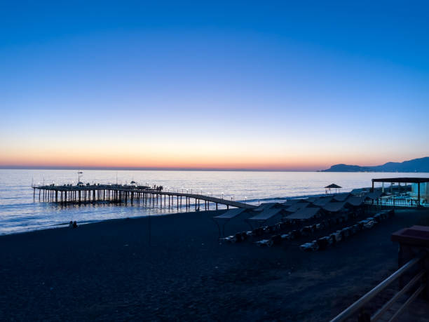 istock Peaceful Beach Sunset Over A Calm Pier And Ocean 2185089593
