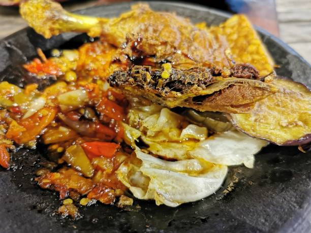 istock Ayam Penyet serving  on a plate complete with vegetables and chili  and it's ready to eat 2185093224