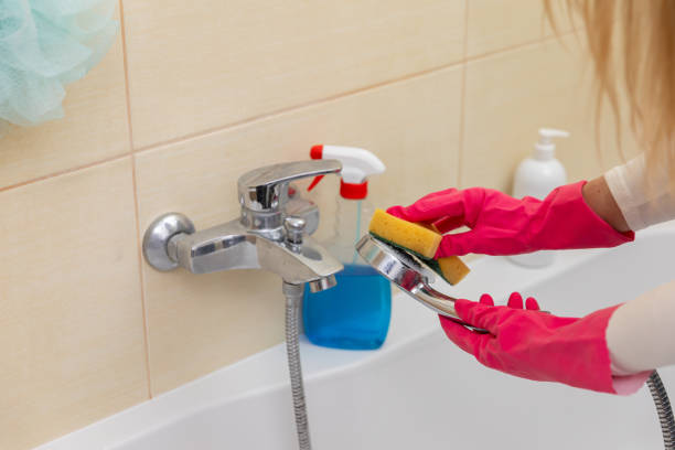 istock Effectively Cleaning Your Bathroom Fixture Using a Sponge and Protective Gloves for Hygiene 2185096765