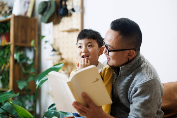 istock Father and son read books together 2185100615