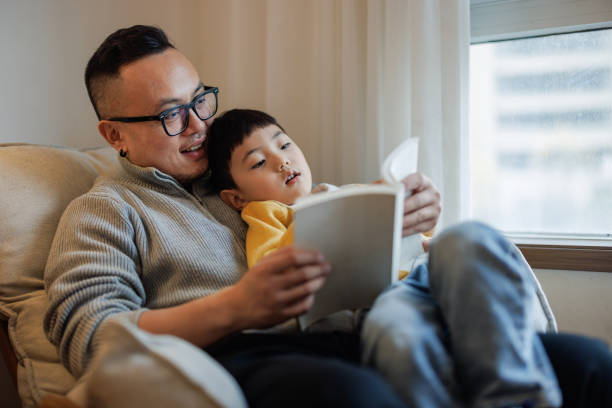 istock Asian father tells stories to his son 2185100636