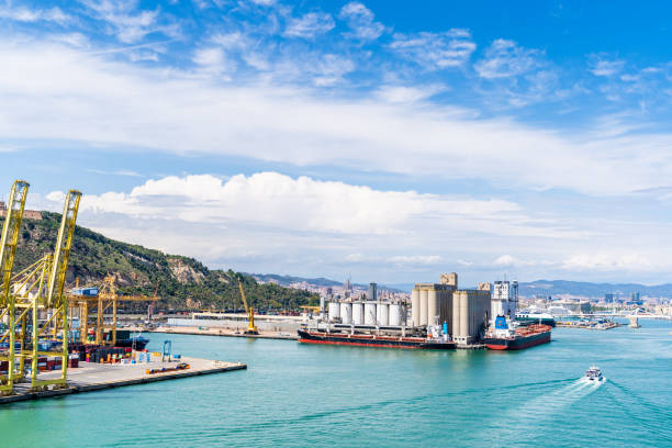 istock Industrial Port in Barcelona with Cranes, Cargo Ships, and Waterfront Silos. 2185106347