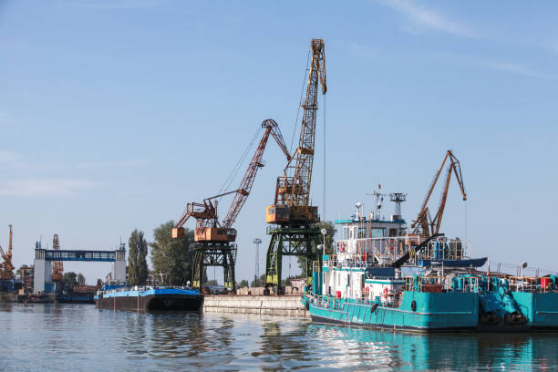 Portal cranes are on the river coast in Bulgarian port Ruse