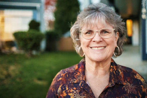 istock Joyful Mature Woman Standing Outdoors at Twilight 2185108339