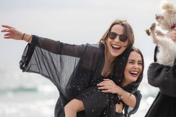 Beautiful ladies are spending time together on the beach.