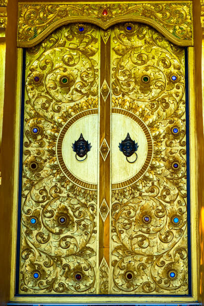Wood carving door in Wat Phra that Doi Phra Chan, a beautiful buddhist temple on the top of mountain in Lampang Province, Thailand.