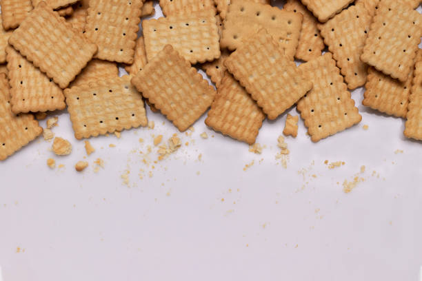 istock white background with crispy cookies and crumbs, copy space 2185112928