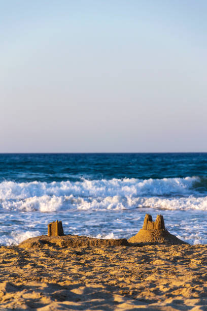 istock Beautiful sand castle on the beach at sunset, childrens creativity, active vacation concept 2185113491