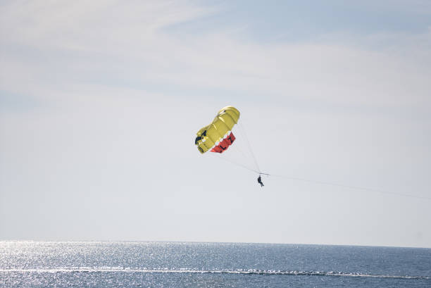istock A couple flies through the air with a parachute 2185115965