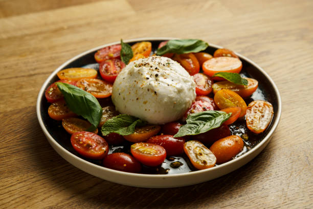 istock Burrata with cherry tomatoes and fresh basil 2185118250