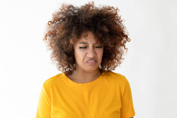 Aggressive mulatto young woman with curly hair. Looking at camera
