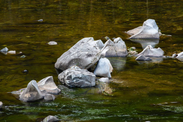 istock rocks and flowing water in the autumn stream 2185122251