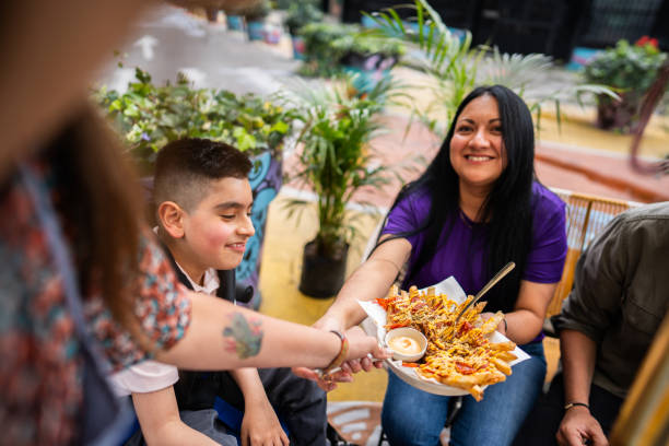 istock Waitress serving family at restaurant 2185124293