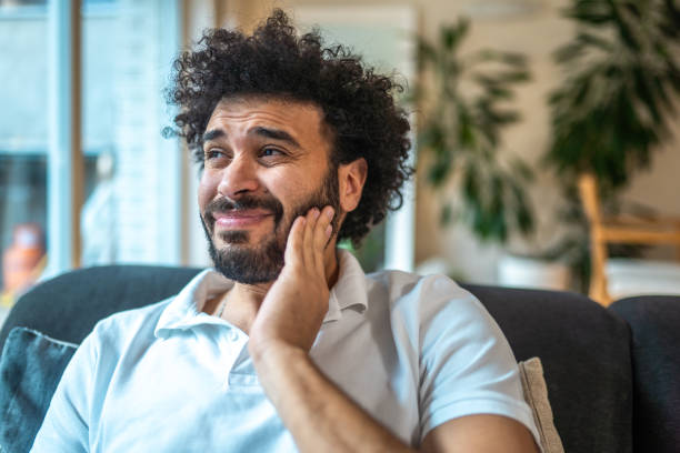 Middle Eastern Man Experiences Toothache While Eating Ice Cream at Home