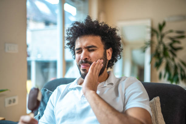 istock Middle Eastern Man Experiencing Toothache While Indulging in Ice Cream at Home 2185125050