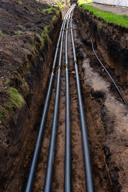istock A collection of black pipes can be seen resting on the dirt surface, creating a striking contrast against the earth, and hinting at potential construction or maintenance work nearby 2185126346