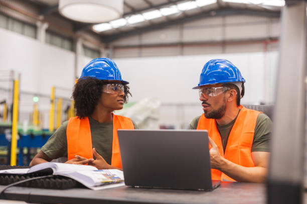 istock Multiracial engineers discussing using laptop in factory 2185128004