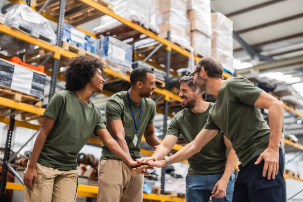 istock Engineers joining hands, celebrating success in robotics factory 2185128181