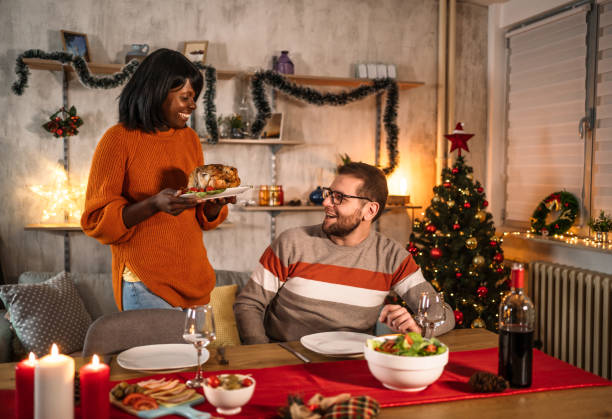 istock Woman setting up the table for Christmas dinner with her boyfriend 2185128590