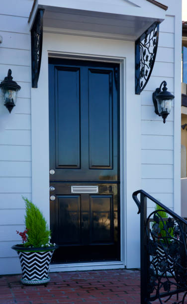 istock White cottage with a black Dutch door 2185129223
