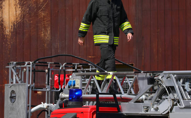 istock firefighter walks on the fire truck ladder during the emergency 2185130197