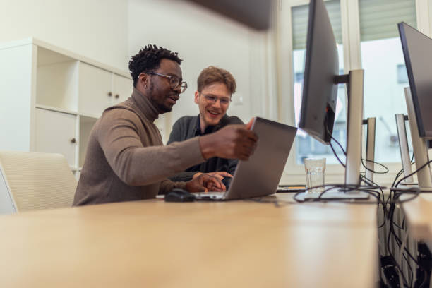istock Two diverse male tech engineers collaborate and work together in the office 2185134147