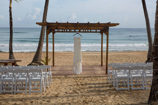 istock Beach Wedding Wooden Canopy with Elegant Wedding Dress on a Seaside Setting 2185135670