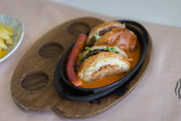 Burger Slice and sausage plate with sauce on plate