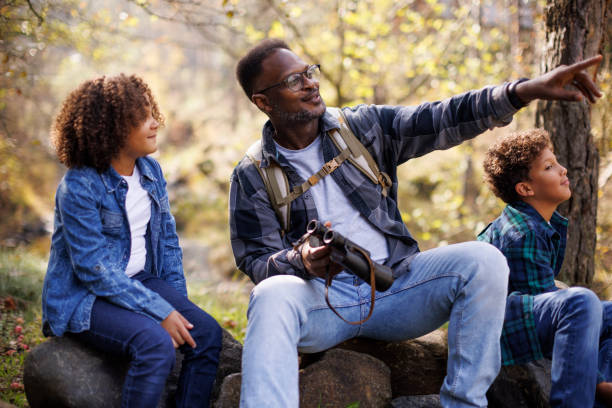 istock Father and his children taking break from hike 2185137339