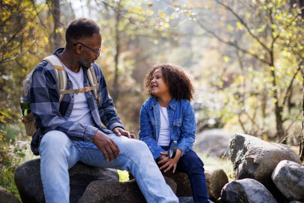 istock Father and his cute daughter taking break from hike in forest 2185137395
