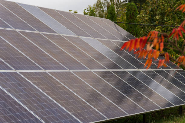 istock Solar panels efficiently generating renewable energy under cloudy skies, surrounded by colorful autumn leaves, showcasing sustainability and technology working in harmony 2185137968