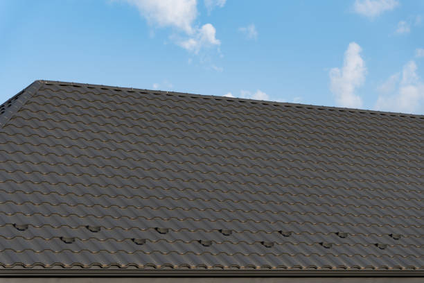 istock The rooftop features stylish tiles with a wave design, reflecting sunlight, while the vibrant blue sky above adds a serene atmosphere to the architecture 2185137969