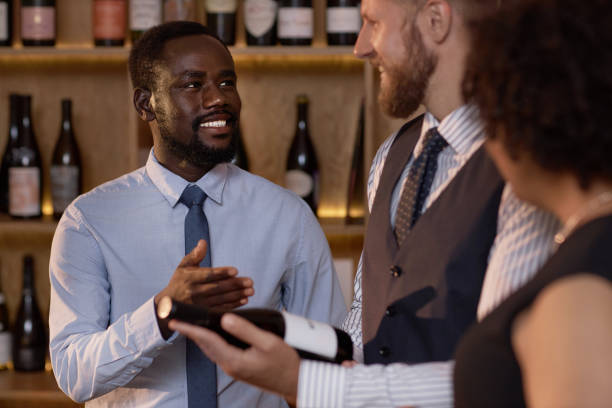 istock Smiling African American Sommelier Interacting with Coworkers 2185139698